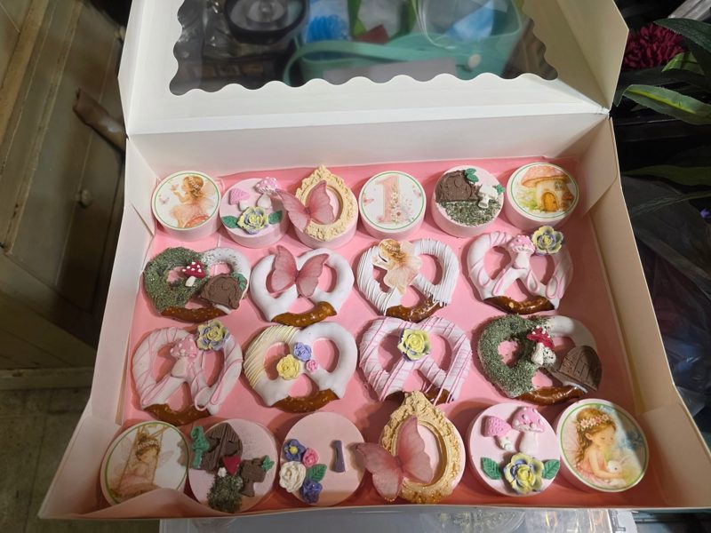 Fairy first birthday party package with decorated pretzels and cookies in a pink box